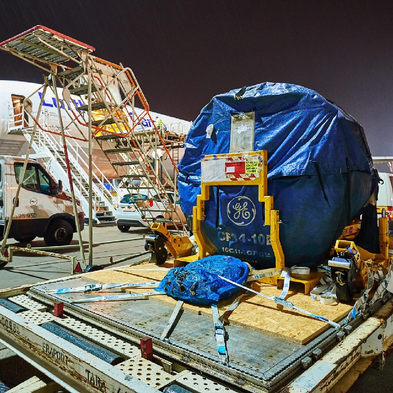  Heavy weight transport object lying next to an aircraft